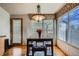 Bright dining area with an elegant light fixture, breakfast table and seating for a cozy meal at 15901 W 66Th Pl, Arvada, CO 80007