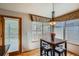 Charming dining area featuring natural light, a modern light fixture, and hardwood floors at 15901 W 66Th Pl, Arvada, CO 80007