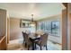 Formal dining room with carpet, chandelier, and natural light from window at 15901 W 66Th Pl, Arvada, CO 80007