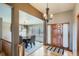 Inviting home entry featuring a wood door, chandelier, and hardwood floors at 15901 W 66Th Pl, Arvada, CO 80007