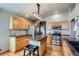 Bright kitchen with stainless steel appliances, island, and oak cabinets at 15901 W 66Th Pl, Arvada, CO 80007