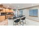 Cozy kitchen featuring wooden cabinets, black countertops, and a breakfast bar with seating at 15901 W 66Th Pl, Arvada, CO 80007