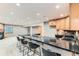 Bright kitchen with a long breakfast bar, seating, and ample cabinet space at 15901 W 66Th Pl, Arvada, CO 80007