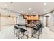 Basement kitchenette with bar seating, dark countertops, and wood cabinets at 15901 W 66Th Pl, Arvada, CO 80007