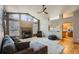 Open living room with fireplace, neutral carpet, and adjacent kitchen view at 15901 W 66Th Pl, Arvada, CO 80007