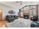 View of living room showcasing vaulted ceiling, fireplace, and modern decor at 15901 W 66Th Pl, Arvada, CO 80007