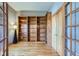 Office room with hardwood floors and built-in wood shelving at 15901 W 66Th Pl, Arvada, CO 80007