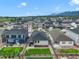 An aerial view shows the neighborhood with well-maintained homes, green lawns, and mountain views in the background at 2130 Indian Balsam Dr, Monument, CO 80132