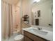 Well-lit bathroom featuring a shower-tub combo, modern vanity, and decorative shelving at 2130 Indian Balsam Dr, Monument, CO 80132