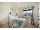 Cozy bedroom with a large window, comfortable bed, and neutral decor at 2130 Indian Balsam Dr, Monument, CO 80132