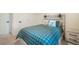 Comfortable bedroom with a large plaid comforter, stylish headboard, and carpeted floor at 2130 Indian Balsam Dr, Monument, CO 80132