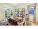 Bright dining room featuring a long wooden table, shelving and a sliding door to the backyard at 2130 Indian Balsam Dr, Monument, CO 80132