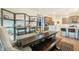 Open dining room with a long wooden table and bench near the kitchen with a center island at 2130 Indian Balsam Dr, Monument, CO 80132