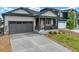 A front yard view of a single Gathering home with neutral paint and a dark driveway at 2130 Indian Balsam Dr, Monument, CO 80132