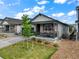 Charming single-Gathering home with a covered front porch, a well-kept lawn, and a stone-accented facade at 2130 Indian Balsam Dr, Monument, CO 80132