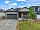 Charming single Gathering home with a well-manicured lawn, covered porch, and two car garage at 2130 Indian Balsam Dr, Monument, CO 80132