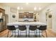 Kitchen with central island with seating, stainless steel refrigerator, and modern countertops at 2130 Indian Balsam Dr, Monument, CO 80132