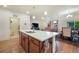 Modern kitchen with a large island, stainless steel sink, and open floor plan at 2130 Indian Balsam Dr, Monument, CO 80132