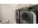 Gray front load washer and dryer in laundry room with shelving and a laundry basket at 2130 Indian Balsam Dr, Monument, CO 80132
