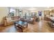 Expansive living room with hardwood floors, comfortable seating, and open concept to kitchen and dining area at 2130 Indian Balsam Dr, Monument, CO 80132