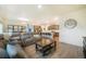 Bright, open-concept living room with hardwood flooring, adjacent to the kitchen and dining area at 2130 Indian Balsam Dr, Monument, CO 80132
