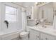 Bright bathroom showcasing a shower-tub combo, white vanity, and decorative mirror at 639 25Th St, Denver, CO 80205