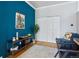 Home office featuring a navy accent wall, a display console, and a sliding door closet at 639 25Th St, Denver, CO 80205