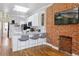 Modern kitchen with white cabinets, stainless steel appliances, and a beautiful brick accent wall at 639 25Th St, Denver, CO 80205