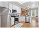 Bright kitchen features stainless steel appliances, white cabinetry, and a view into the living area at 639 25Th St, Denver, CO 80205