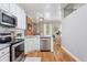 Kitchen with stainless steel appliances, white cabinetry, and an open layout leading to the living area at 639 25Th St, Denver, CO 80205