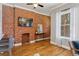 Cozy living room boasts exposed brick and hardwood flooring at 639 25Th St, Denver, CO 80205