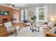 Comfortable living room featuring exposed brick, two windows, and stylish furniture at 639 25Th St, Denver, CO 80205
