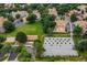 Aerial view of townhouses with well-manicured landscaping, and a community sand volleyball court at 8406 Everett Way # C, Arvada, CO 80005