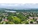 Aerial view of community with a park and lake with a circled townhouse at 8406 Everett Way # C, Arvada, CO 80005