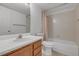 This bathroom features a shower-tub combo and wood vanity, with a clean and functional design at 8406 Everett Way # C, Arvada, CO 80005