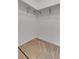 This empty walk-in closet includes metal shelving and neutral carpeting, perfect for organizing your wardrobe at 8406 Everett Way # C, Arvada, CO 80005