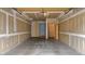 This is an empty two-car garage with a concrete floor, drywall, and interior doors at 8406 Everett Way # C, Arvada, CO 80005