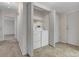A convenient laundry room with tile floor and a closet, including a washer, dryer, and shelving at 8406 Everett Way # C, Arvada, CO 80005