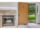 Living room with fireplace and an open front door leading to a green yard at 8406 Everett Way # C, Arvada, CO 80005