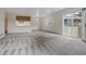 Bright living room with sliding doors to a balcony and an open bar to the kitchen at 8406 Everett Way # C, Arvada, CO 80005