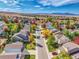 Stunning aerial view of a community with colorful fall foliage and mountain views at 1462 Hyacinth Way, Superior, CO 80027