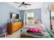 Charming bedroom features a bright blue wall, TV, bed, and plenty of natural light at 1462 Hyacinth Way, Superior, CO 80027