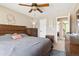 Comfortable bedroom features a wooden bed frame, ceiling fan, soft lighting, and neutral decor at 1462 Hyacinth Way, Superior, CO 80027