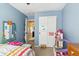 Bright bedroom featuring blue walls, a closet with white doors, and ' decor at 1462 Hyacinth Way, Superior, CO 80027