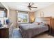 Serene bedroom features a large bed, wooden furniture, and a bright window, creating a relaxing retreat at 1462 Hyacinth Way, Superior, CO 80027