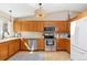 Functional kitchen featuring hardwood floors, wooden cabinets and stainless steel appliances at 1462 Hyacinth Way, Superior, CO 80027