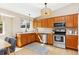 Well-lit kitchen featuring wooden cabinets, stainless steel appliances, and hardwood floors at 1462 Hyacinth Way, Superior, CO 80027