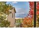 Scenic view of mountains framed by a tan home exterior and vibrant autumn foliage at 1462 Hyacinth Way, Superior, CO 80027