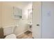 Compact bathroom featuring a toilet, wall cabinet, and vanity sink with good lighting, perfect for guests at 13472 E Dakota Ave, Aurora, CO 80012
