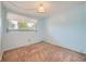 Bedroom is bright with blue walls, tan carpet, and a large window for natural light at 13472 E Dakota Ave, Aurora, CO 80012